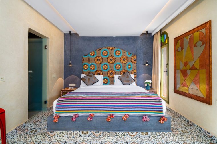Suite with a zellige headboard and hand-painted panels