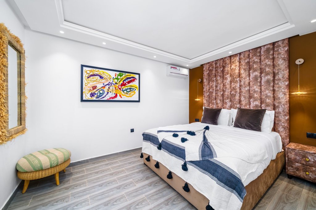 Second bedroom of the apartment, dressed in white and indigo