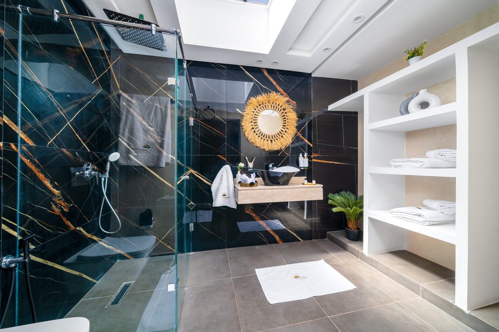 Marble bathroom of the family apartment with a walk-in shower