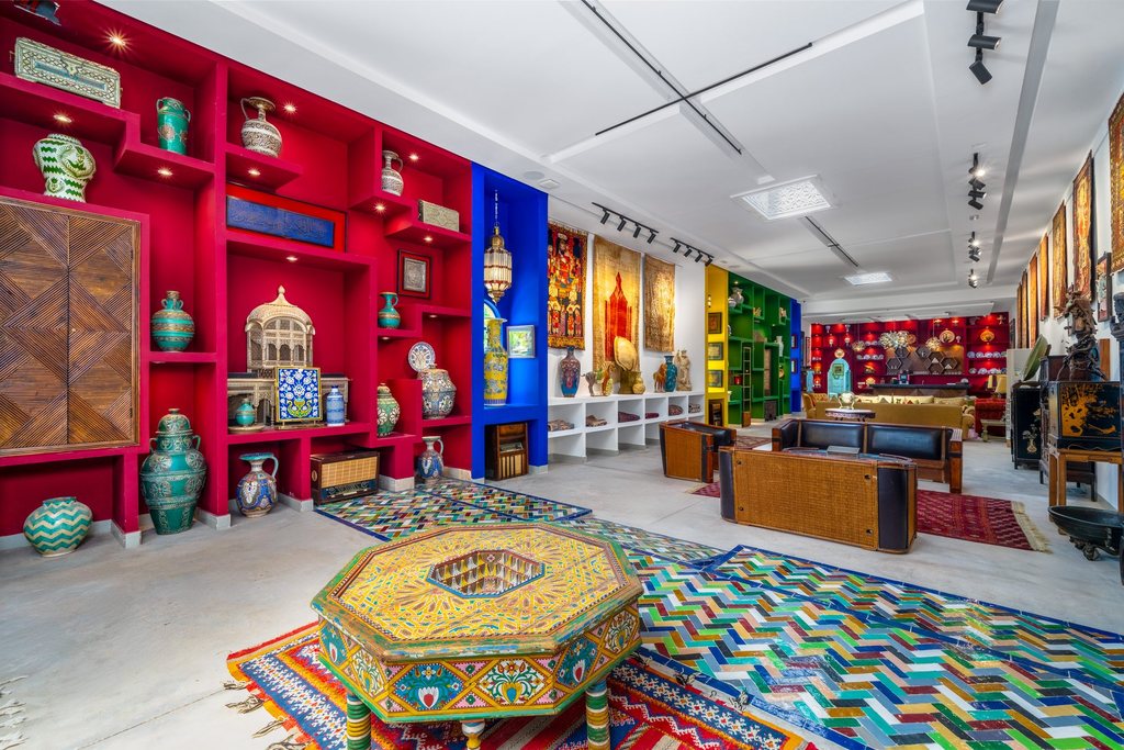 Painted chests, lanterns and ceramics along the gallery walls