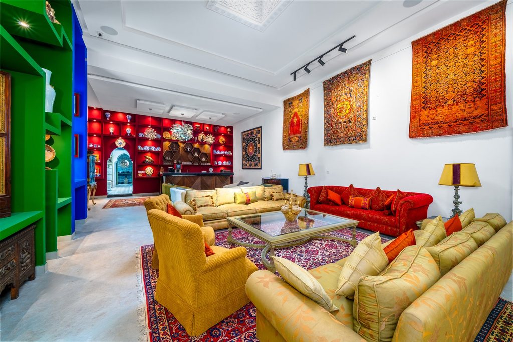 Salon set among the collected carpets and cabinets