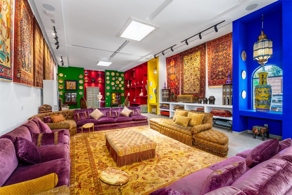 Purple banquettes and a gold-threaded rug in the collection room