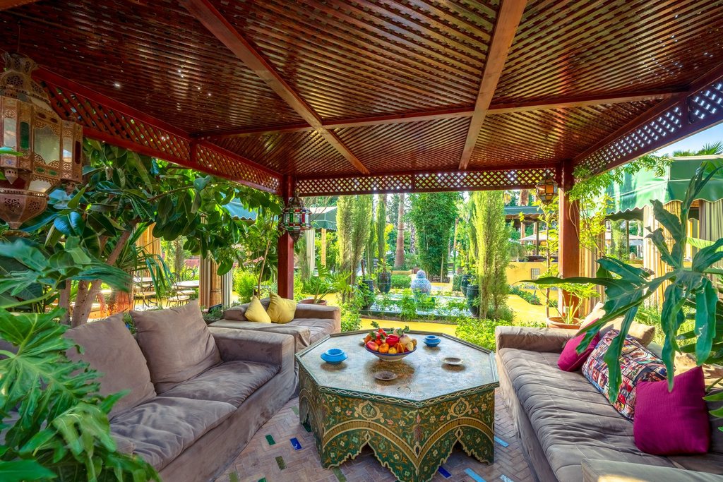 Cedar pergola with low banquettes and Moroccan rugs