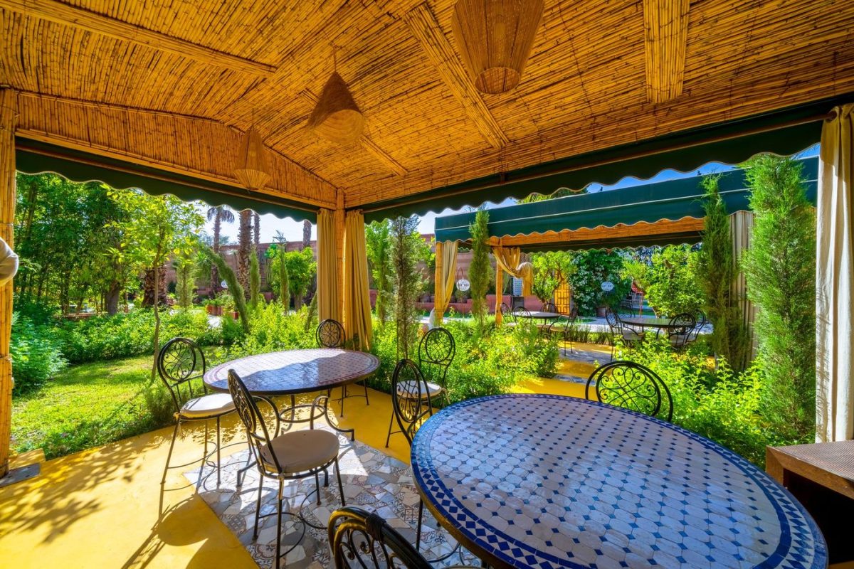 Shaded garden pavilion with a long table, set for a seminar