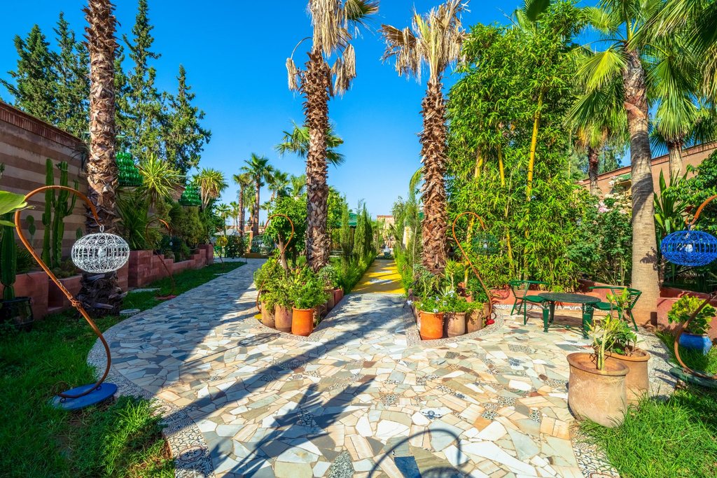 A quiet corner of the estate, cacti and potted plants along a stone path