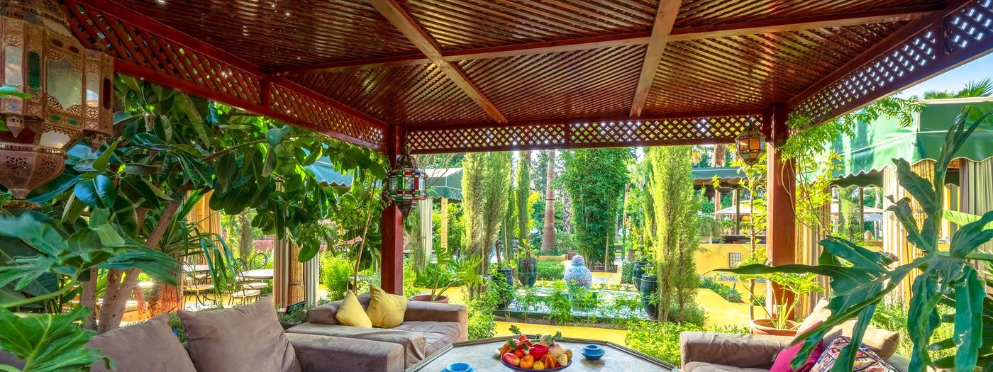 The cedar pergola at Jnane Rihane, low banquettes and cushions for resting after the hammam