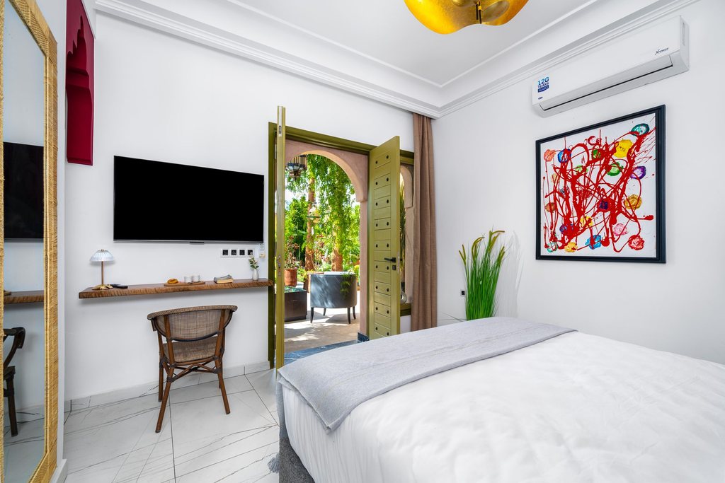 Writing desk, mirror and television in a standard room at Jnane Rihane