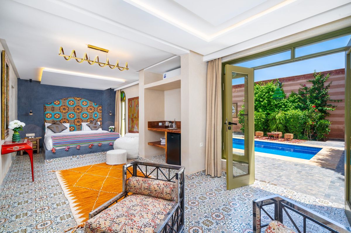 Bedroom of a suite looking through to its private pool
