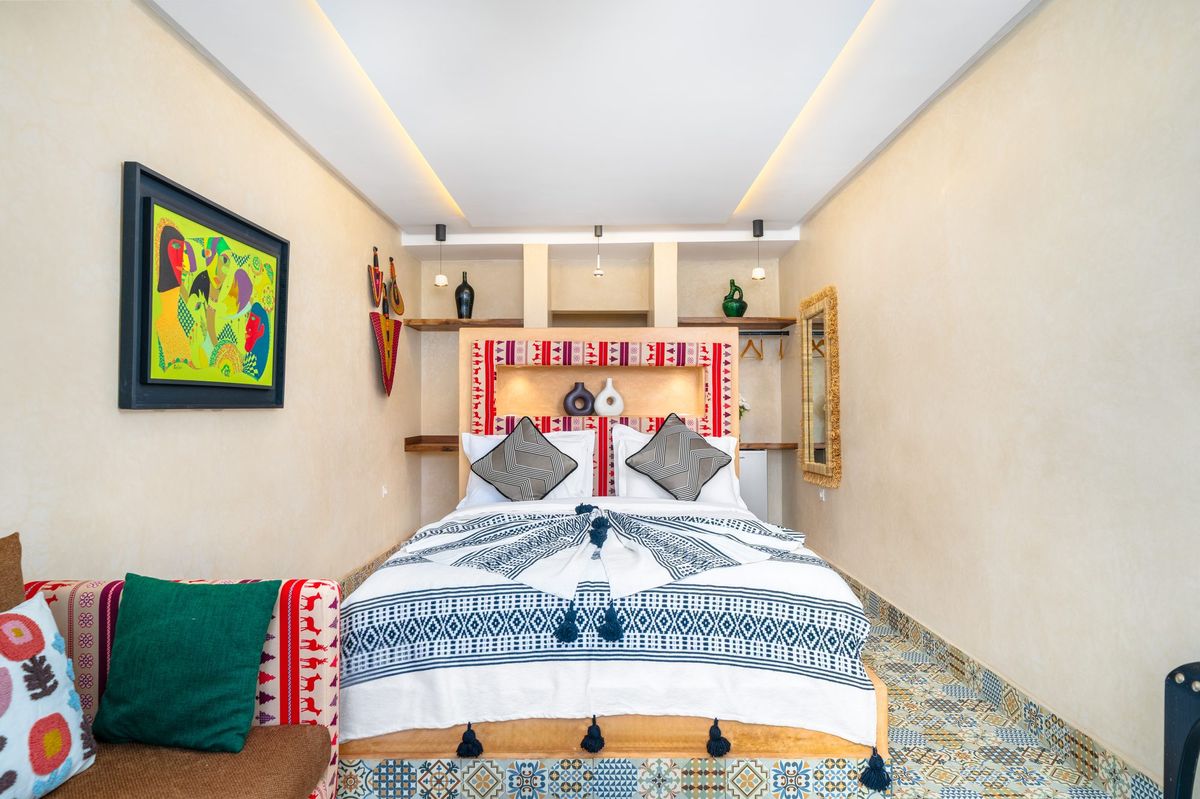 Deluxe room with an embroidered headboard set in a carved alcove