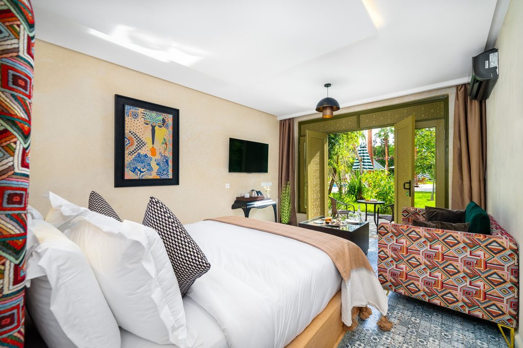 Deluxe room opening onto the gardens through green doors